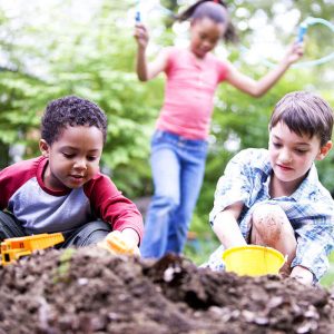 Preschoolers digging in dirt
